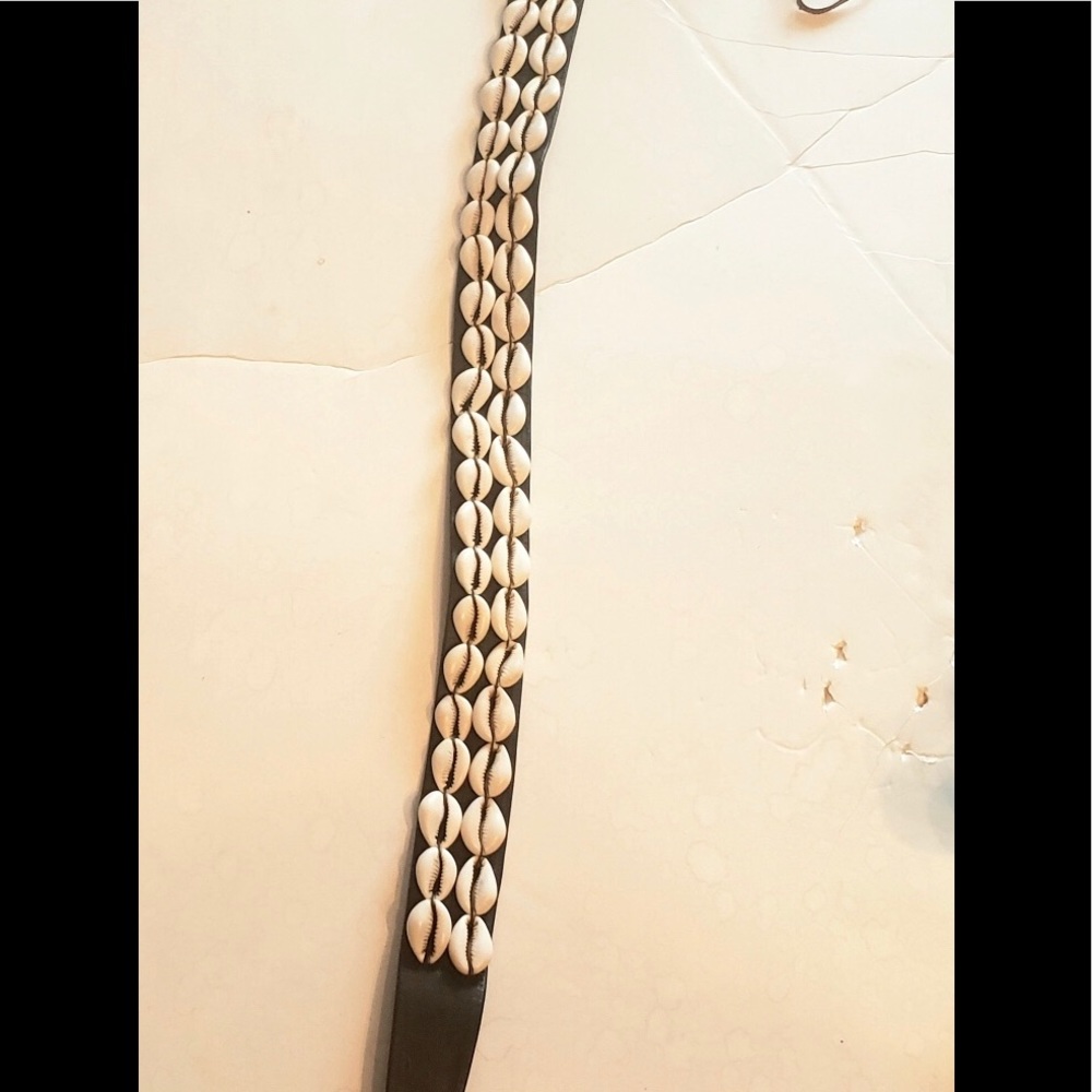 Two beaded cowrie shell beads on leather belt 36”
